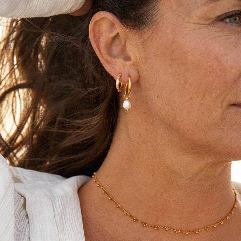 Freshwater Pearl Bella Hoop Earrings worn by a woman in her fifties